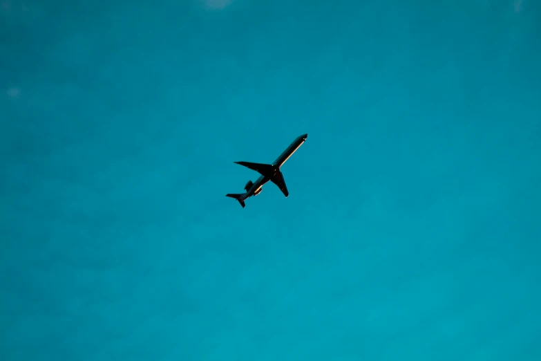 an airplane in a sky near some trees