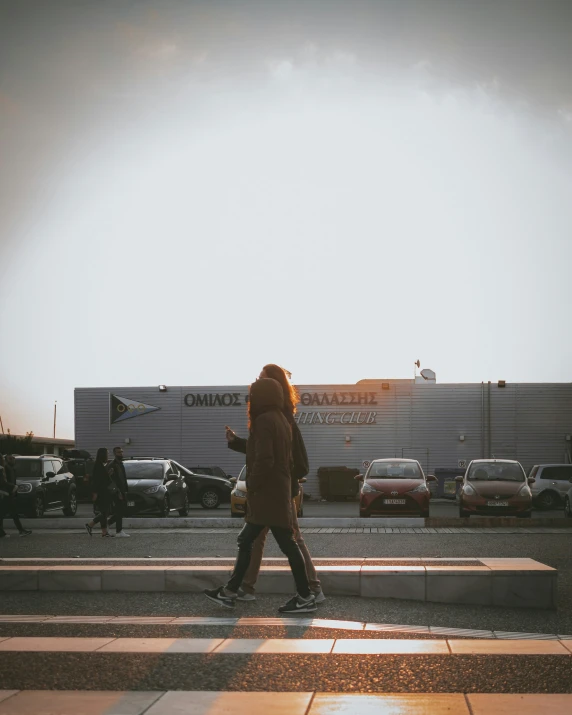 a woman walks through the street of an airport