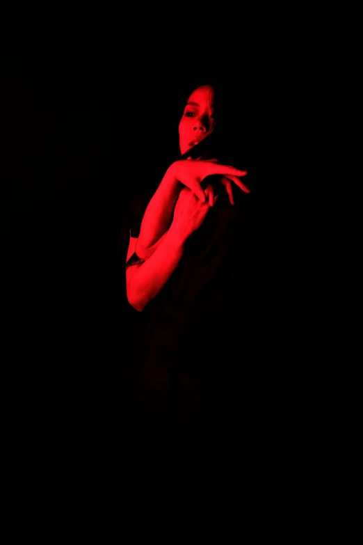 a woman is shown dancing in the dark