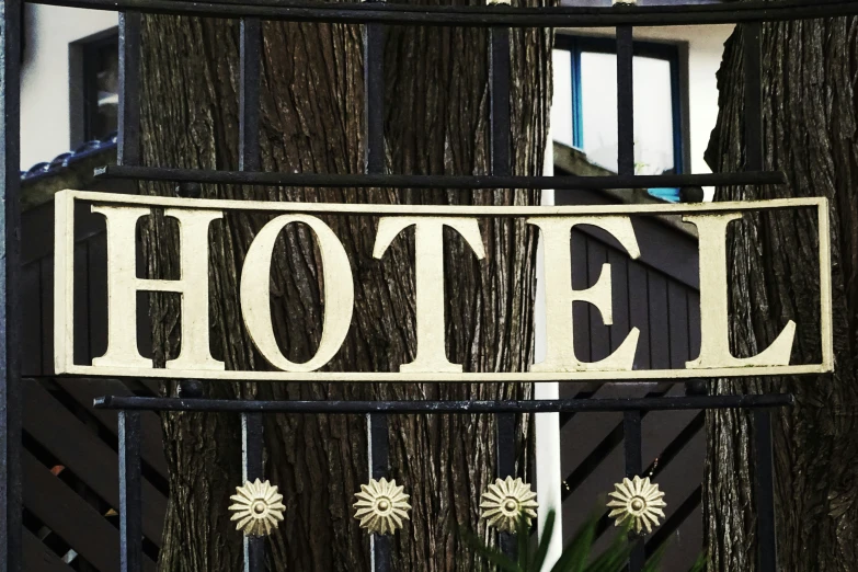 an el sign mounted to the side of a metal fence