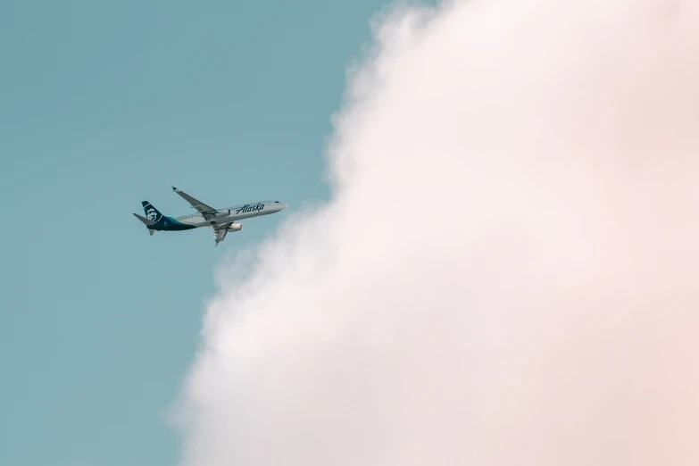 there is an airplane that can be seen through the clouds