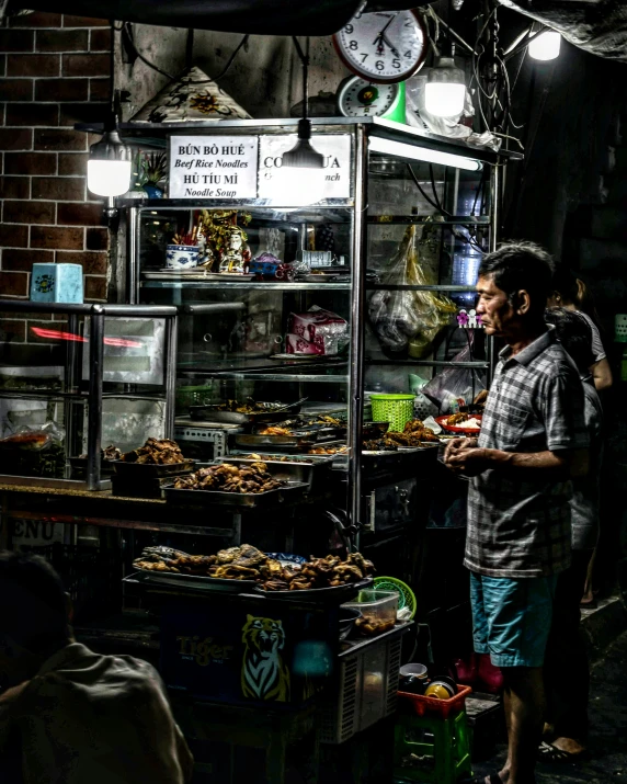 a person standing by an outdoor restaurant with food