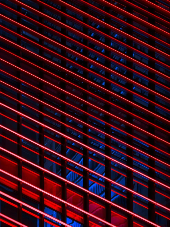 the side of a building is illuminated with red light