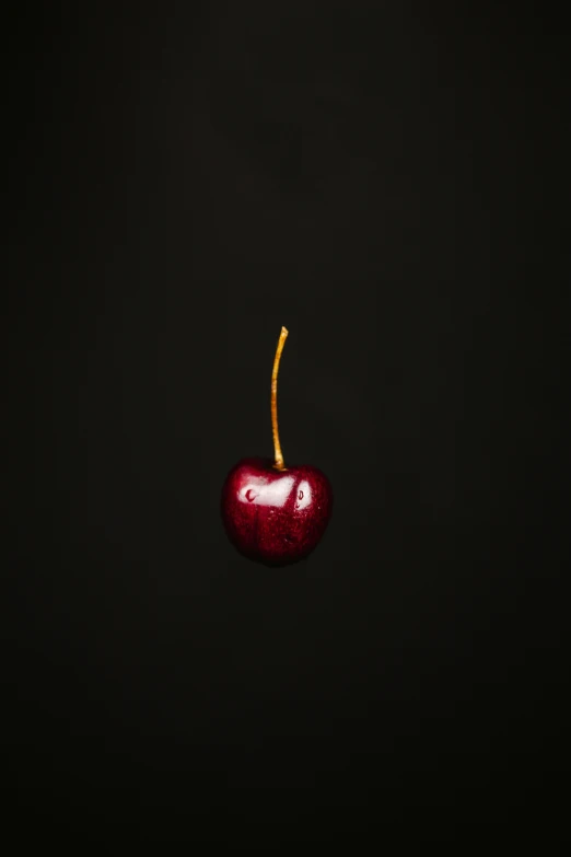 there is an apple with a cherry shaped face