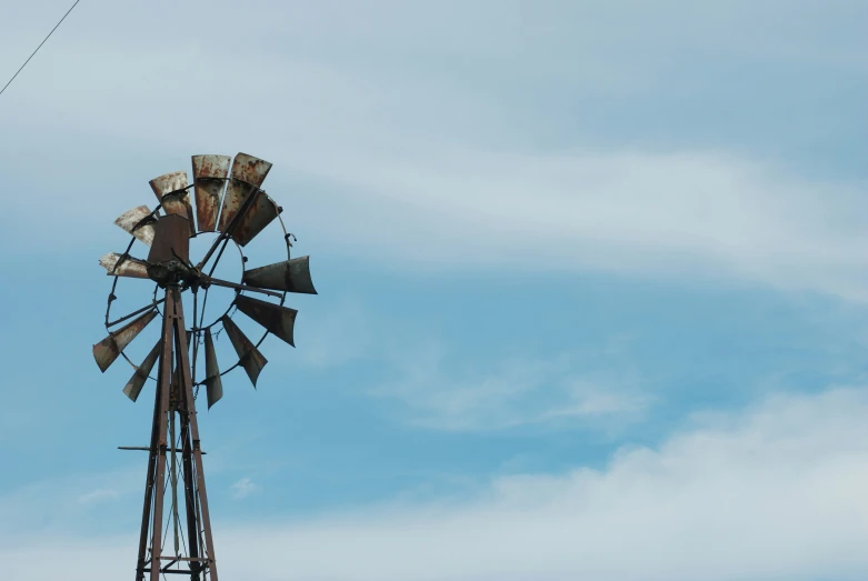 the old, rusty windmill is standing tall