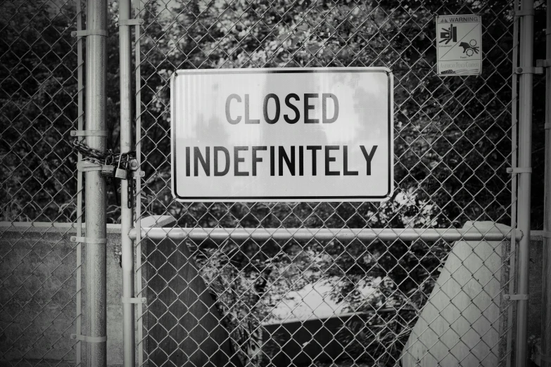 a fenced area with a sign saying closed confidently