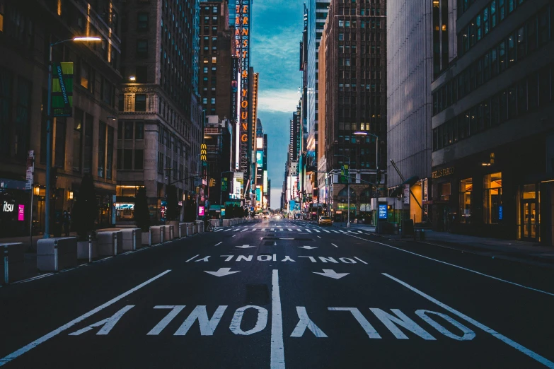 a road with directional markings in the middle of the street