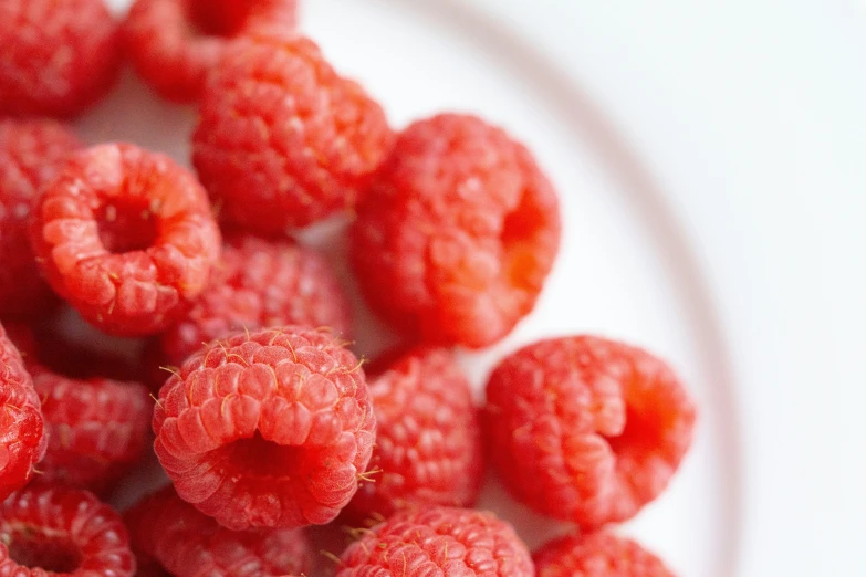 a bowl with red berries and water on it