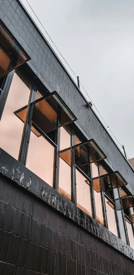 the windows are looking out from the outside of a building