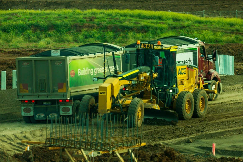 a tractor with a large trailer drives along the road