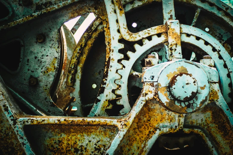 the rusted wheels and gears of an old steam - powered machine