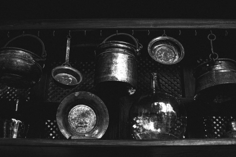 a shelf with many pots and pans on it