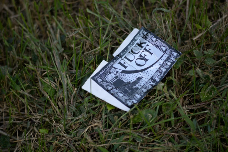 a book sitting on the grass in front of it