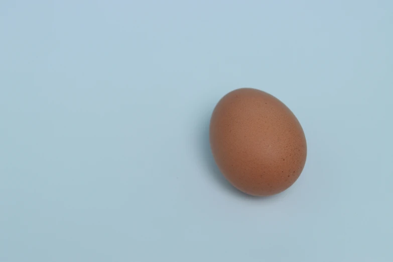 an egg is laying on a blue surface