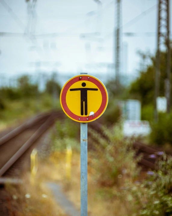 an odd looking sign on the rail road tracks