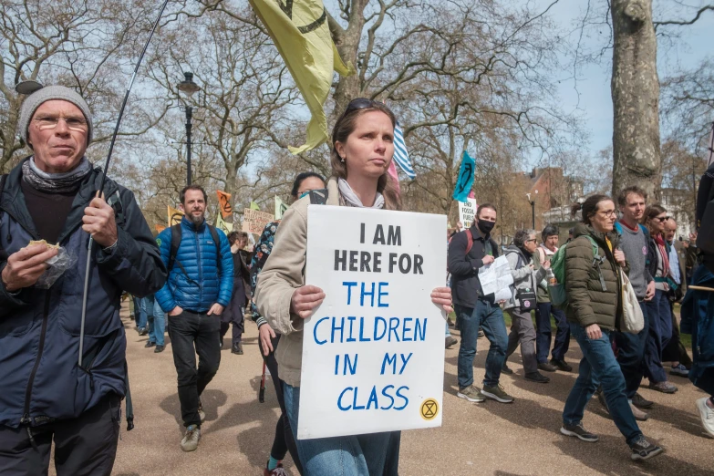 protestors in an occupy - in - town demonstration carrying signs