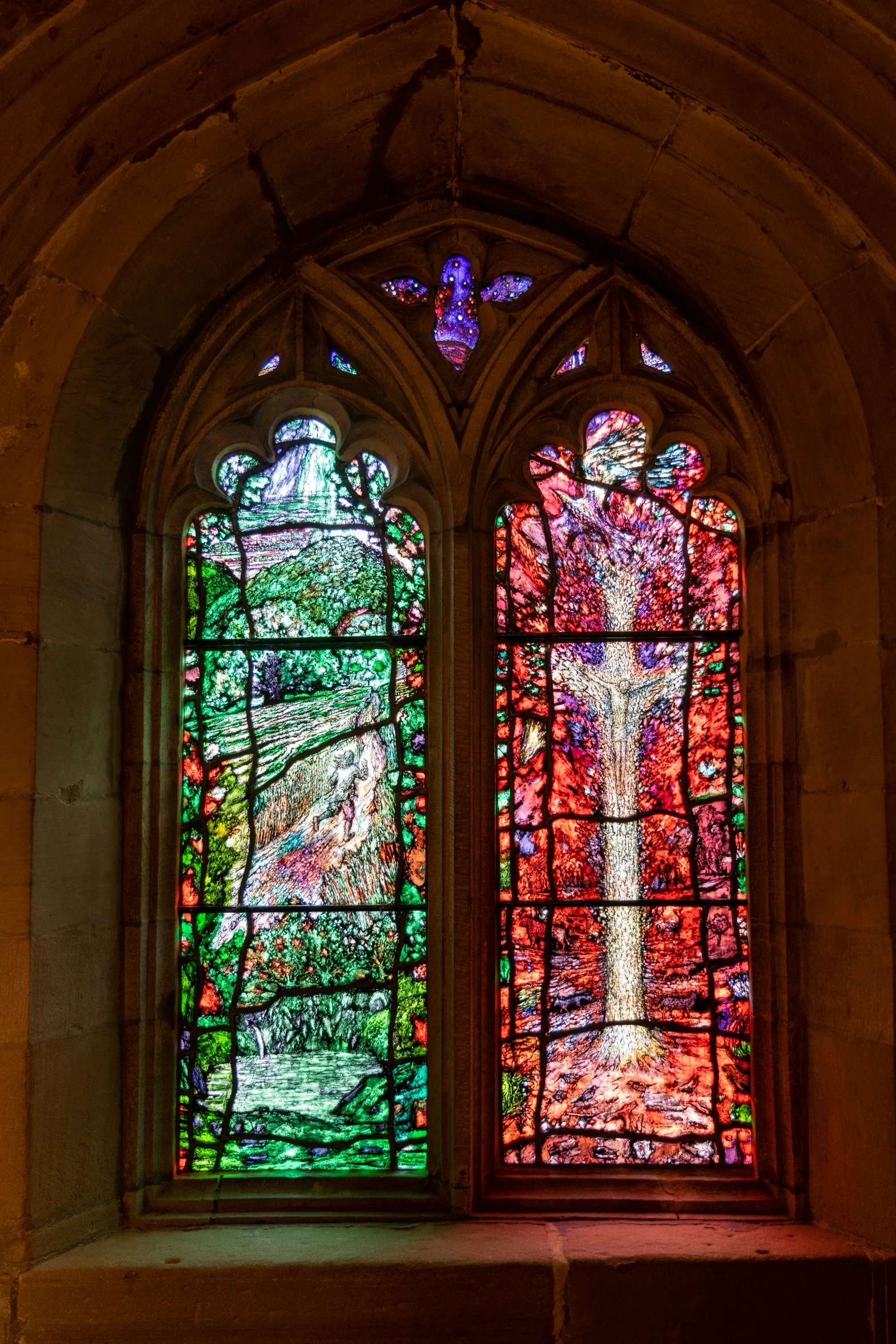 stained glass windows in an old stone church