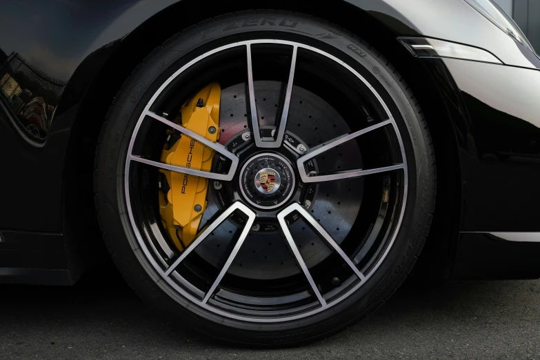 the wheel of a black sports car