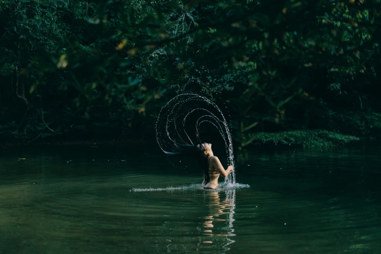 person with arms open out in the water