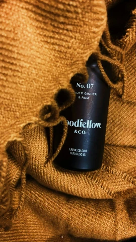 a bottle of modiclow next to a pile of brown linen