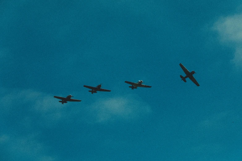 three airplanes are flying through the air with one landing gear deployed