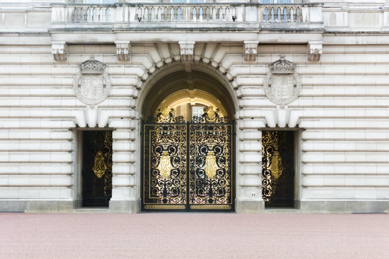 a man walking past a door with gold doors