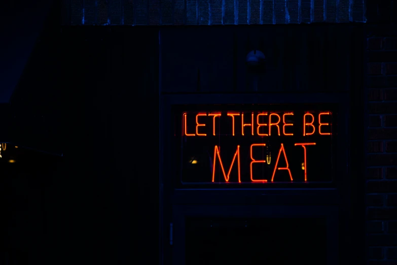 a sign that reads let there be meat