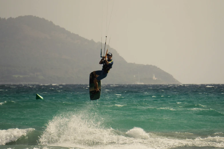 a kite boarder does a flip on the water