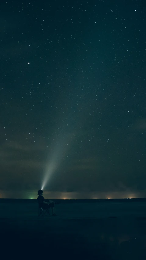 man on horseback under star - filled sky with stars