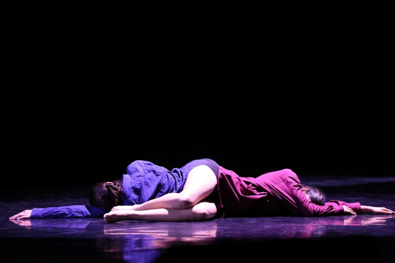 a woman laying on top of a bed in purple