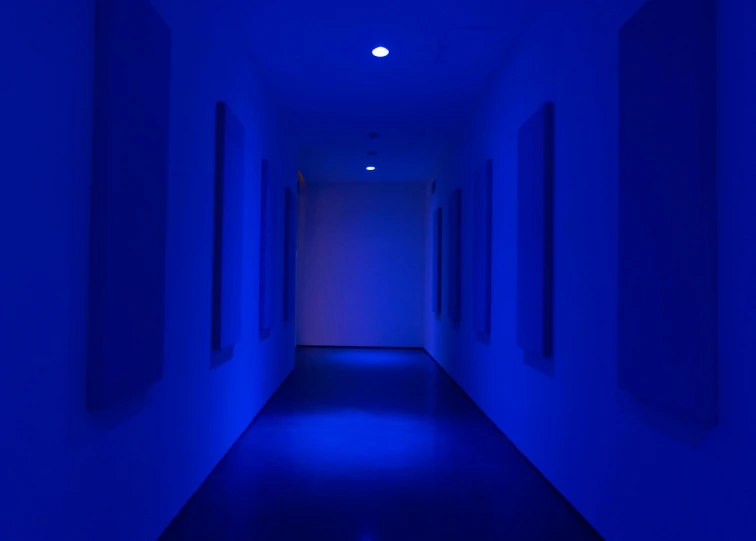 an empty hallway with blue lights is shown