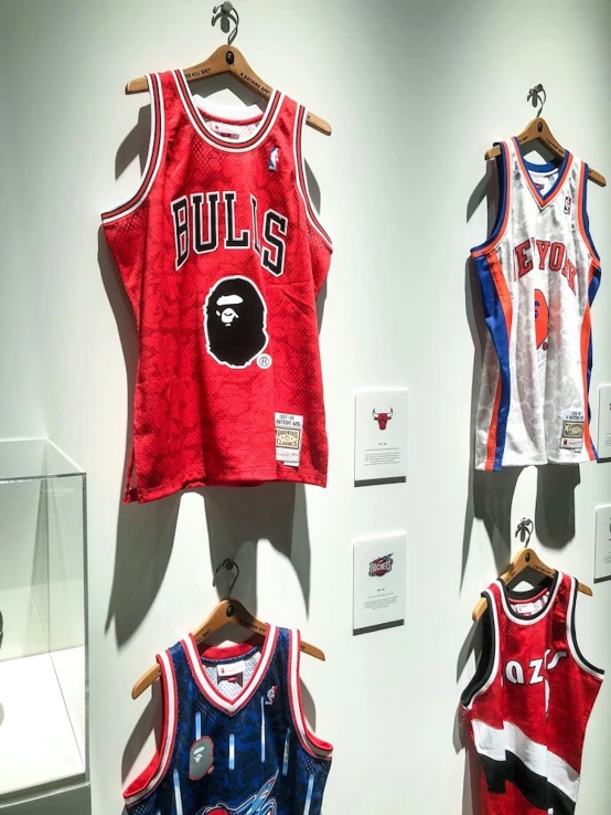 a collection of chicago bulls uniforms hanging on wall