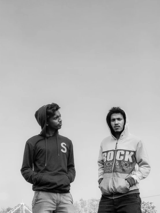 two people in jackets with hoods and sweatshirts