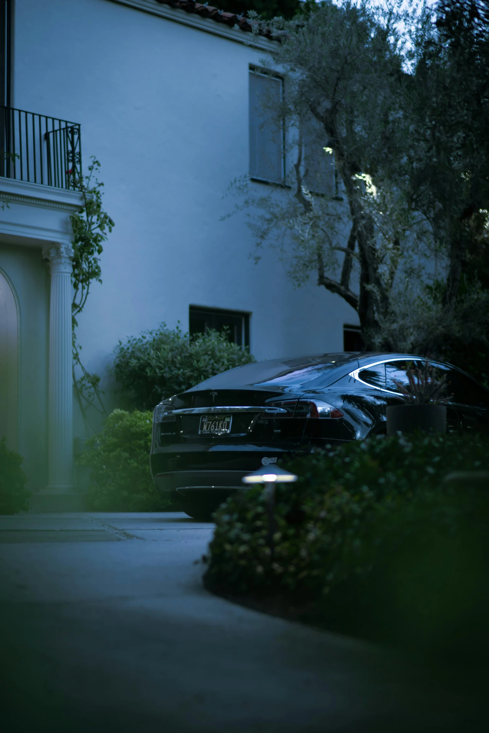 a car parked on a road by a house