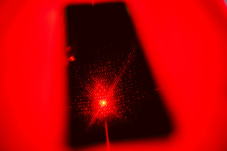 a view from the top of a cell phone that appears to be reflected in red light