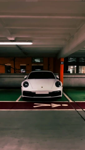 a white car sitting inside a parking garage