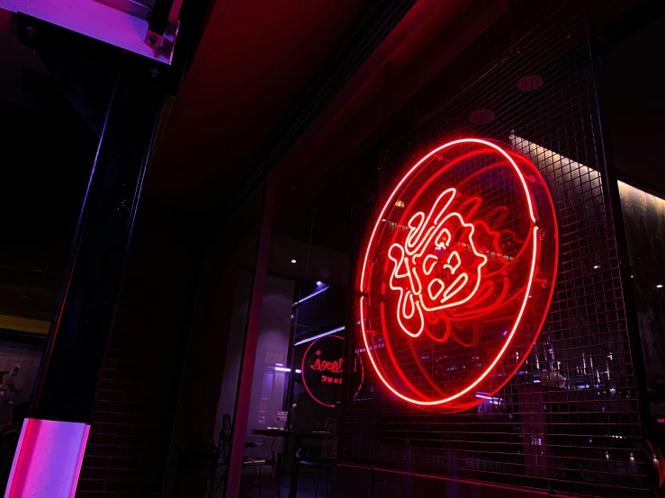 a neon sign with an arabic calligraphy on it