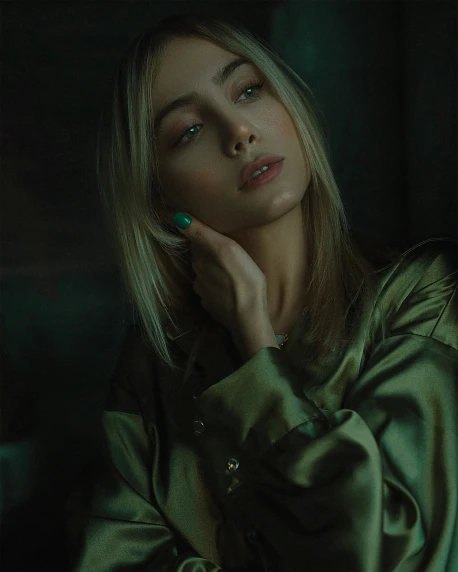 a beautiful blond woman wearing a shiny green coat