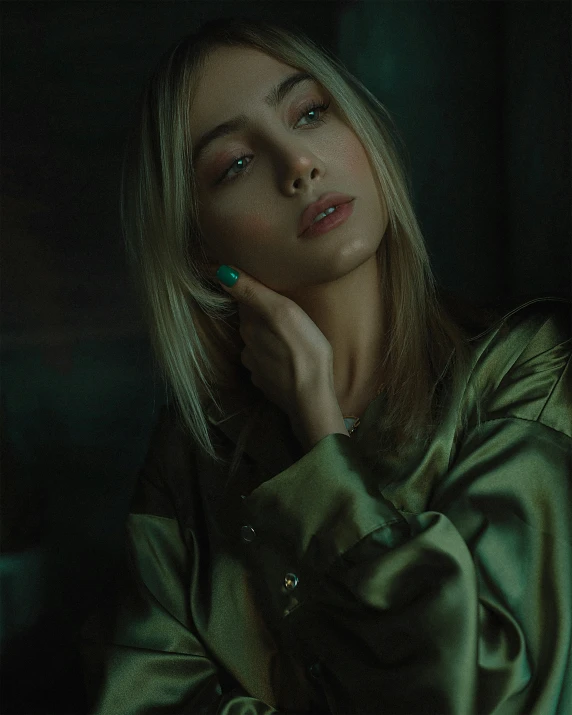 a beautiful blond woman wearing a shiny green coat