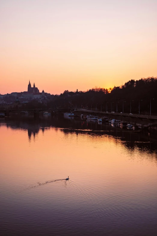 a boat floating on top of a lake near a town