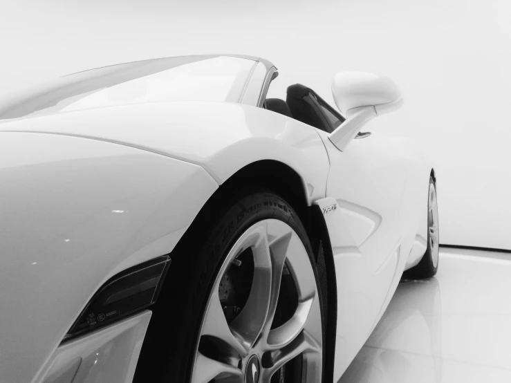 a very sleek white sports car is parked in a modern building