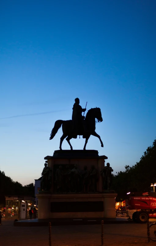 the equestrian statue is standing in front of a truck