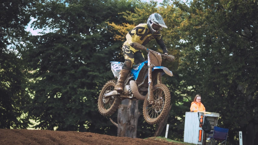 a man jumping on a dirt bike over a log