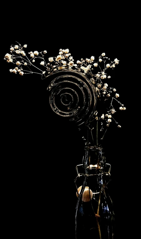 a vase filled with white flowers on top of a black table