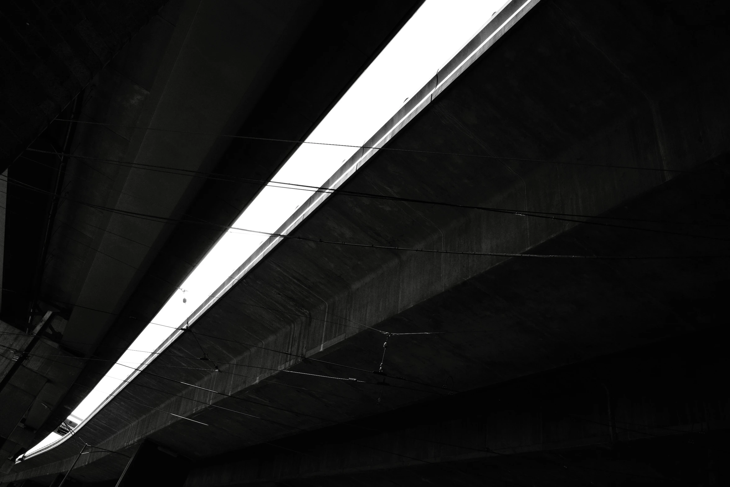 a very long bridge with bright lights going into the sky