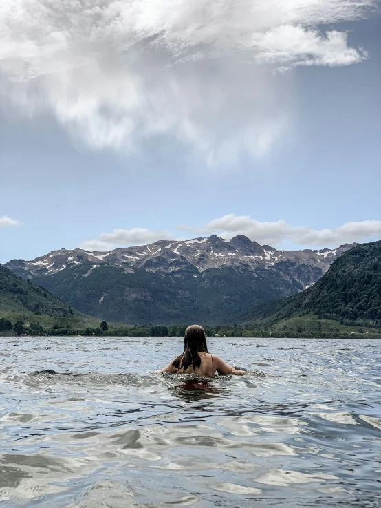 a woman is swimming in a body of water