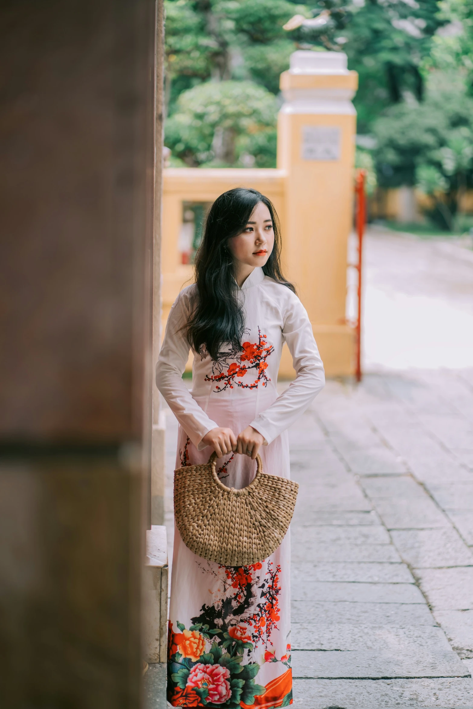 a woman leaning against the wall with her handbag