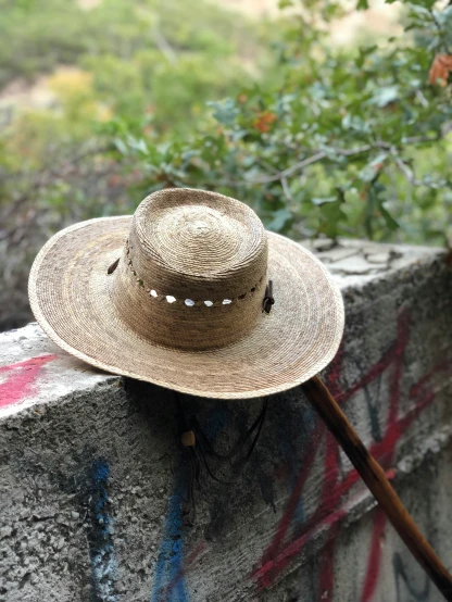 a hat on top of a wall with graffiti in the background