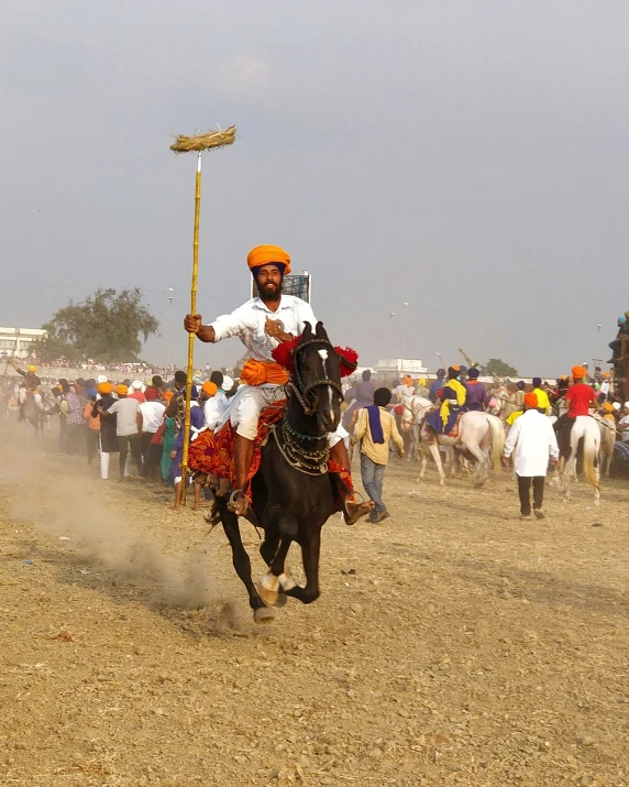 a man rides his horse in a desert like setting