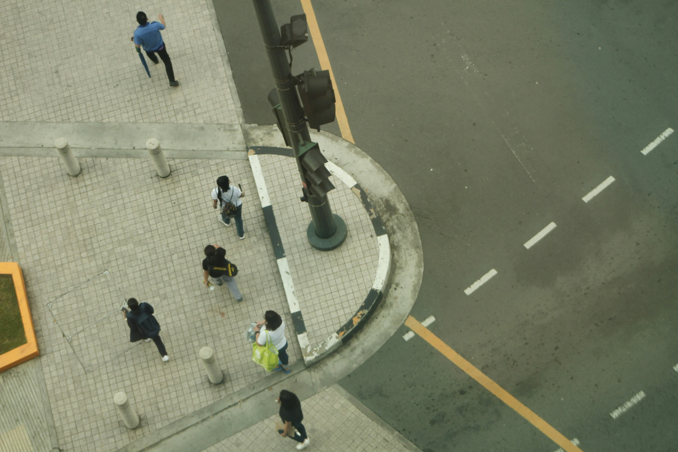 a group of people walking down a street next to street signs